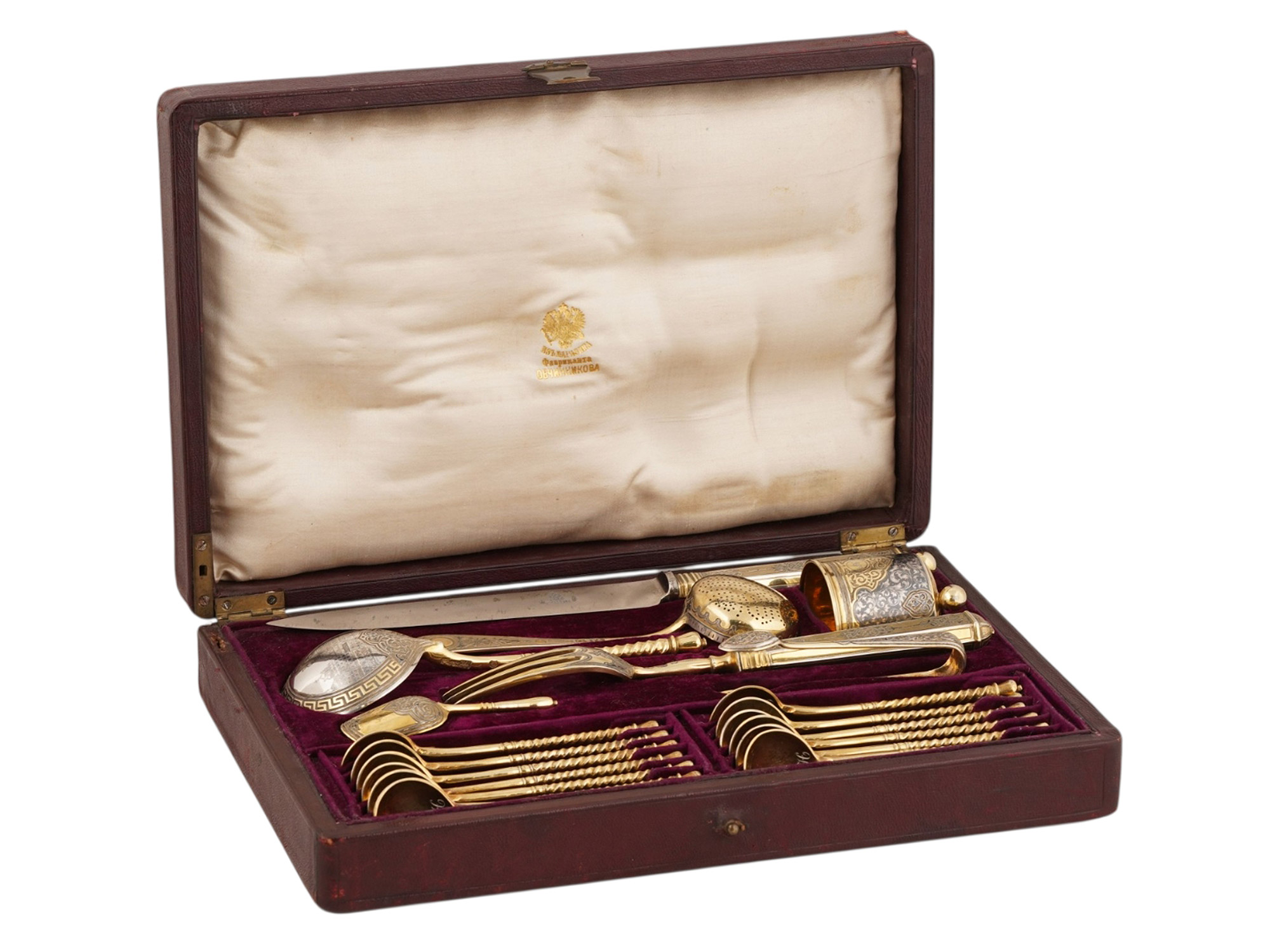 A RUSSIAN CASED SILVER-GILT AND NIELLO TABLEWARE SET, PAVEL OVCHINNIKOV, MOSCOW, 1868