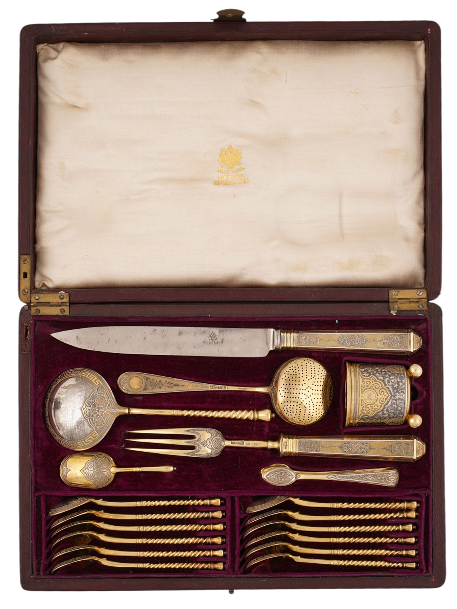 A RUSSIAN CASED SILVER-GILT AND NIELLO TABLEWARE SET, PAVEL OVCHINNIKOV, MOSCOW, 1868