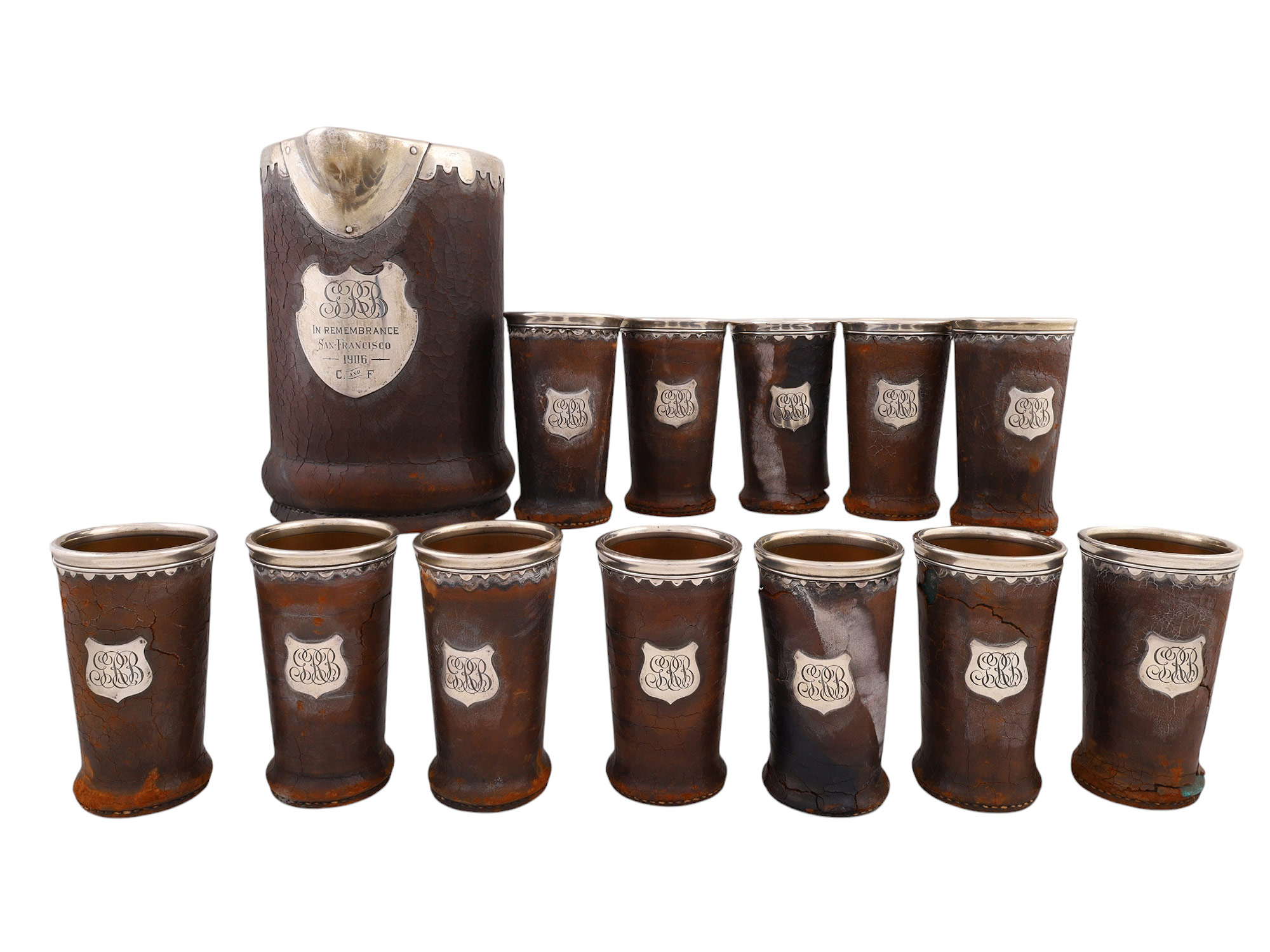 A 1906 SAN FRANCISCO FIRE AMERICAN GORHAM SILVER AND LEATHER DRINKING SET, 13 PIECES AND NEWSPAPER
