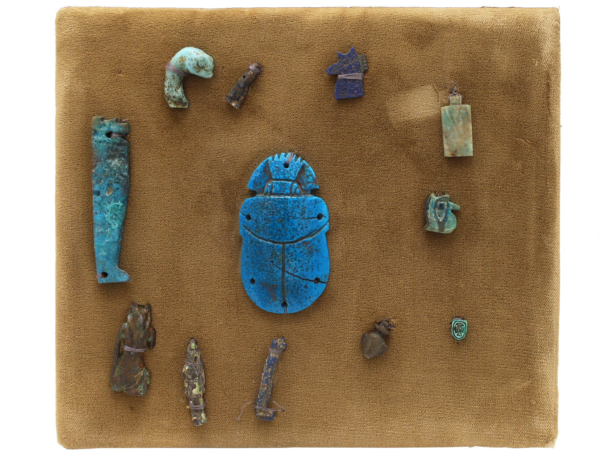 A GROUP OF 12 ANCIENT EGYPTIAN FAIENCE, STEATITE AND BRONZE AMULETS