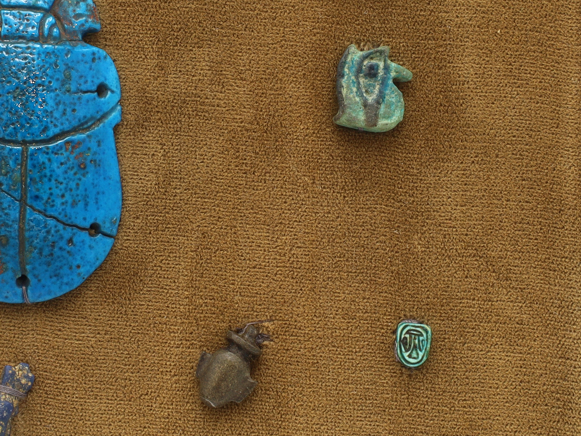 A GROUP OF 12 ANCIENT EGYPTIAN FAIENCE, STEATITE AND BRONZE AMULETS
