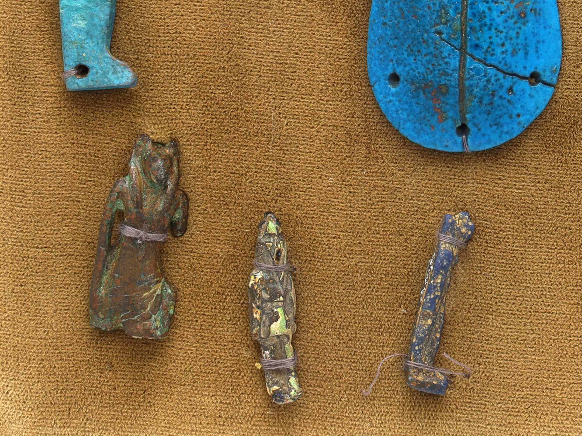 A GROUP OF 12 ANCIENT EGYPTIAN FAIENCE, STEATITE AND BRONZE AMULETS