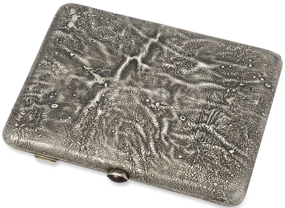 RUSSIAN SILVER-GILT SAMORODOK CIGARETTE CASE WITH A RED CABOCHON
St Petersburg, 1908-1917. Hallma 