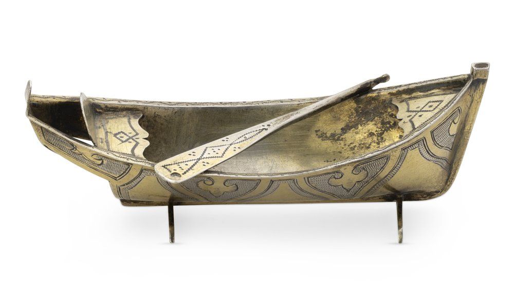 RUSSIAN SILVER-GILT SALT CELLAR SHAPED AS A BOAT WITH PADDLE
St Petersburg, 1899-1908. Hallmarks: 
