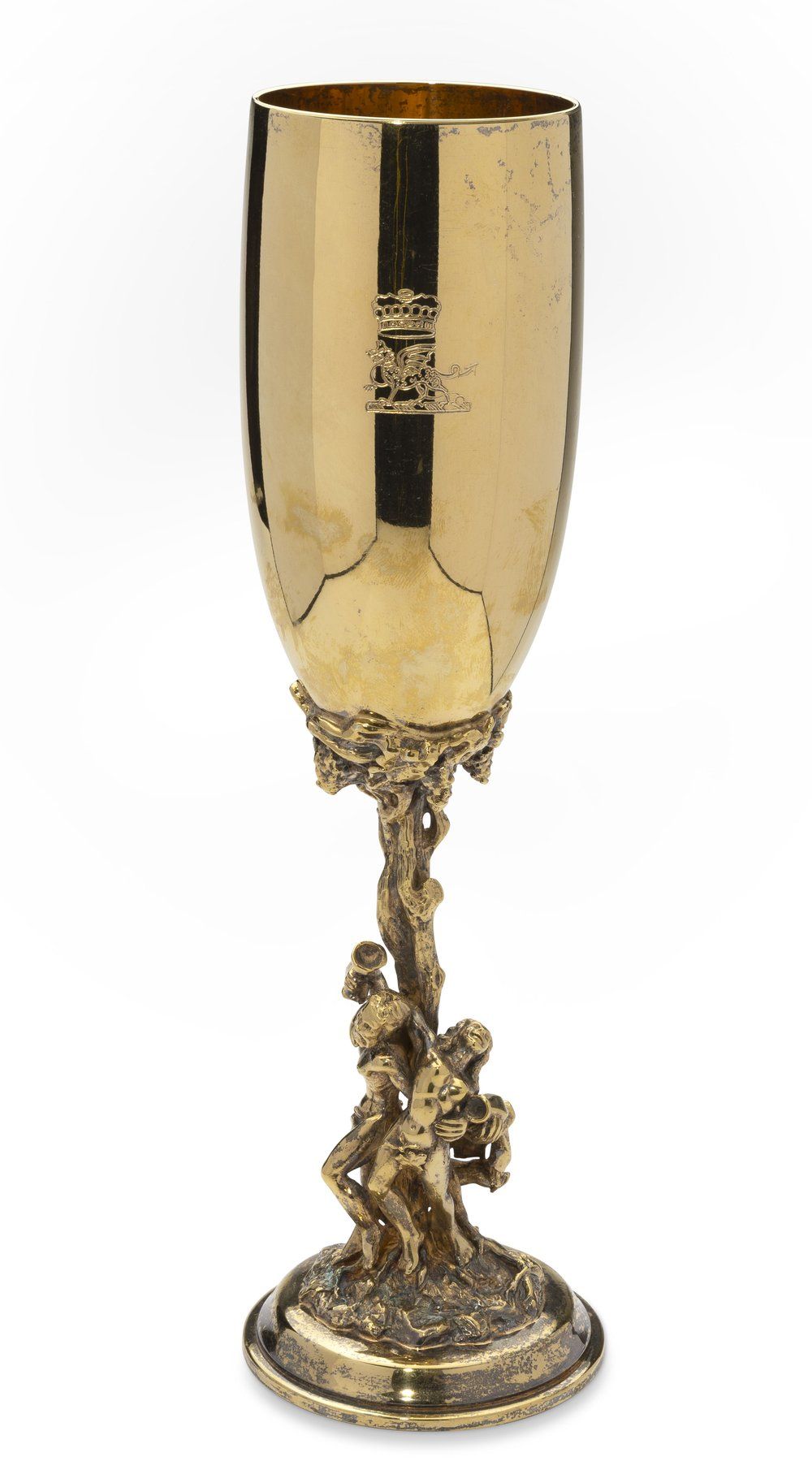 SILVER-GILT CHAMPAGNE FLUTE WITH ENGRAVED COAT OF ARMS AND BACCHANAL SCENE. stem features a 