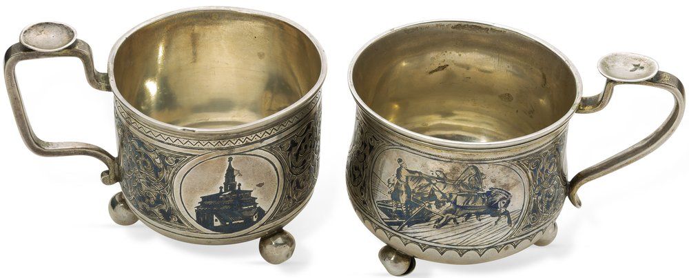 PAIR OF RUSSIAN PARCEL-GILT SILVER AND NIELLO GLASS HOLDERS. Unknown maker’s mark ‘PM’ , assay 