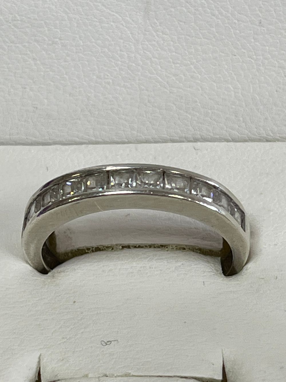 Lot 179: Clear stone half eternity ring set in silver...
