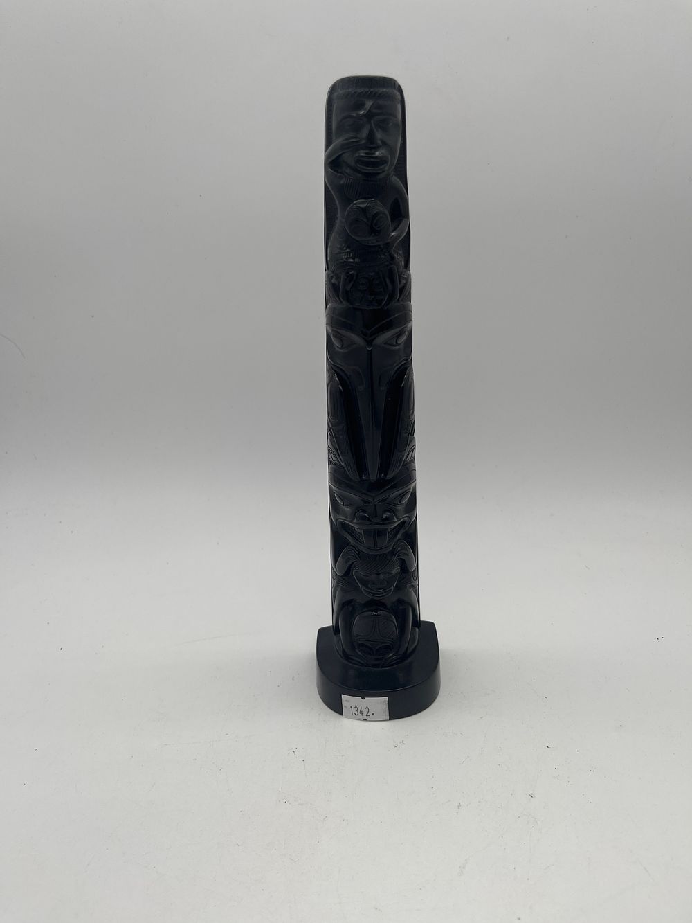 Lot 255: Small black wood  totum pole