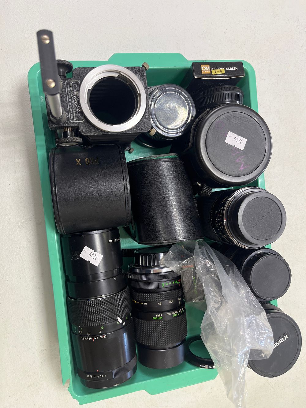 Lot 273: A tray full of camera lenses and other...