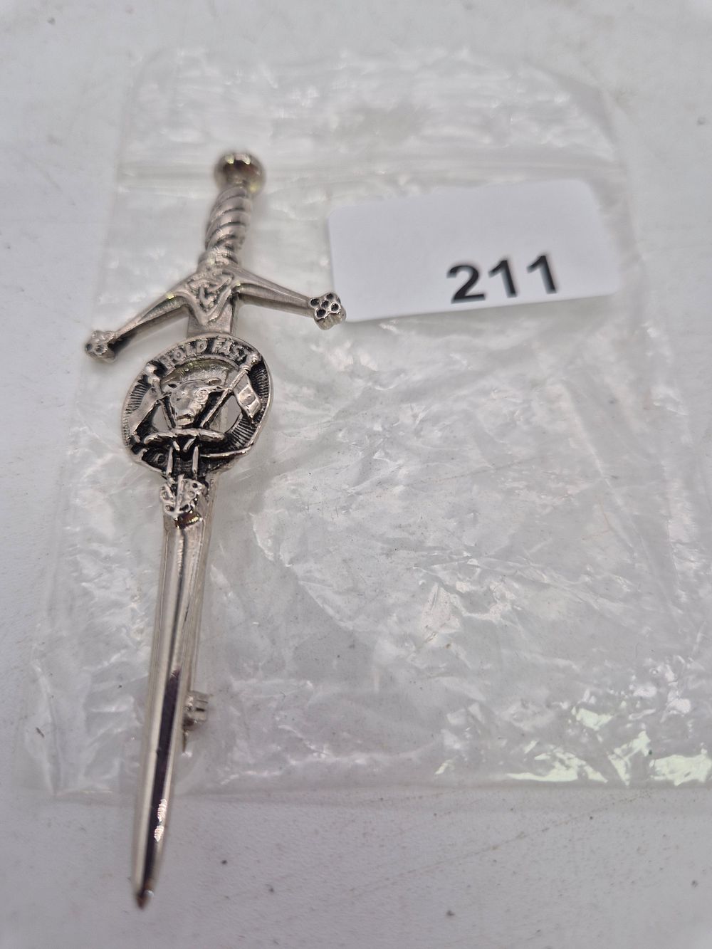 Lot 211: White metal sword pin