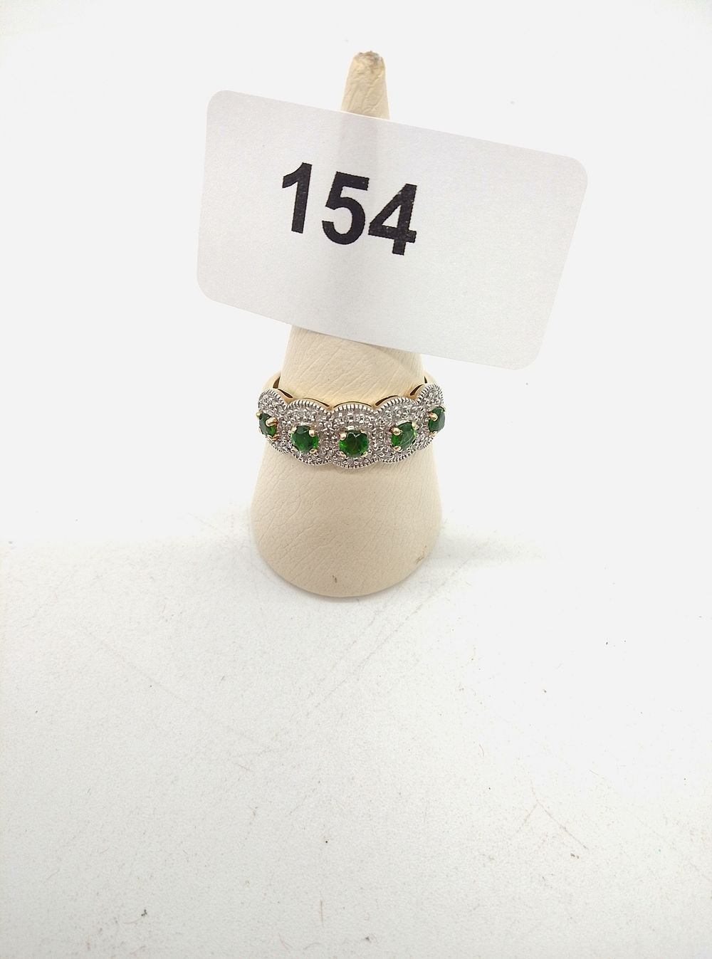 Lot 154: A 9ct Gold and Russian Diopside Five-Stone Cluster...