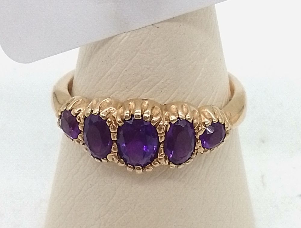 Lot 156: A 9ct Yellow Gold Five-Stone Amethyst Ring