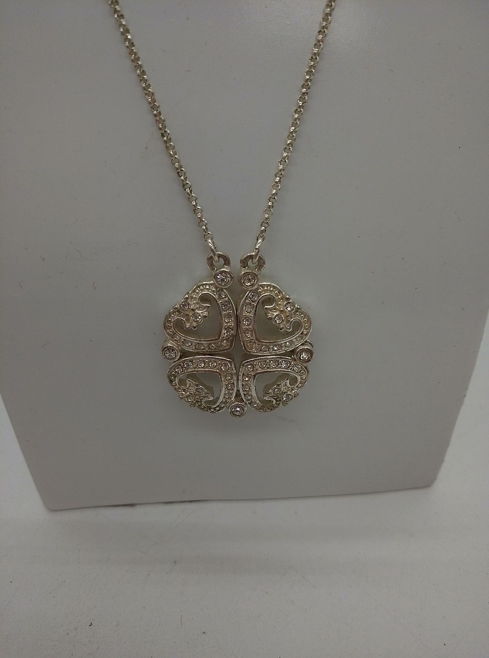 Lot 170: A white-tone metal convertible four-leaf clover and heart...