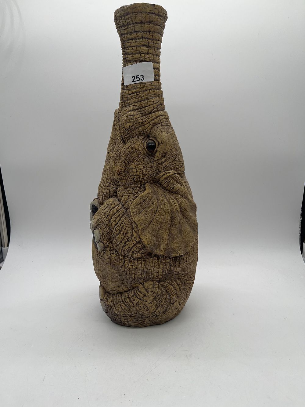 Lot 253: A decorative elephant-form resin figurine and vessel