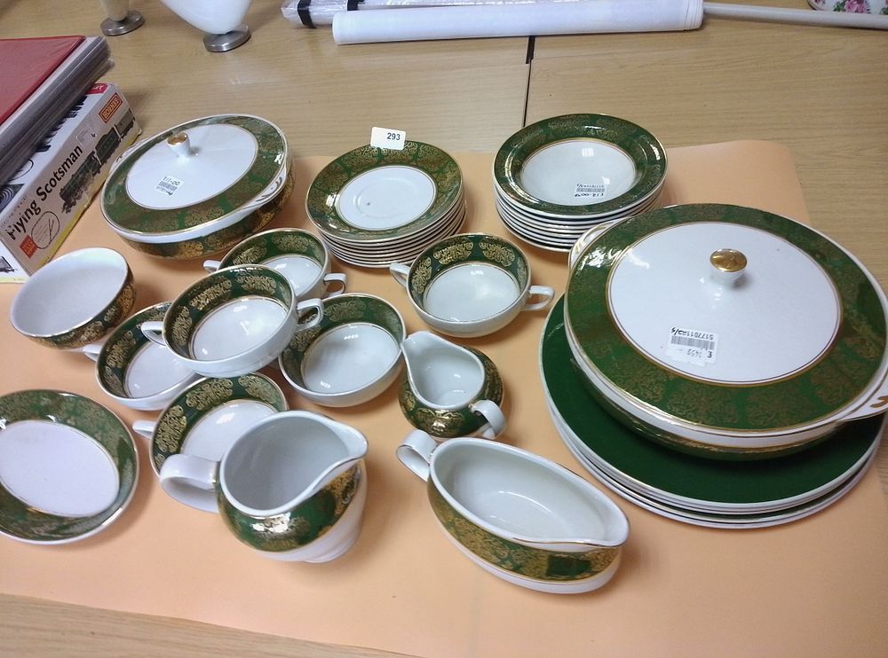 Lot 293: A partial porcelain dinner service with emerald green...