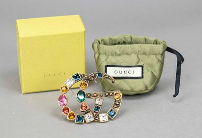 Gucci, large costume jewelry logo brooch, bronze-coloured metal with differently faceted 