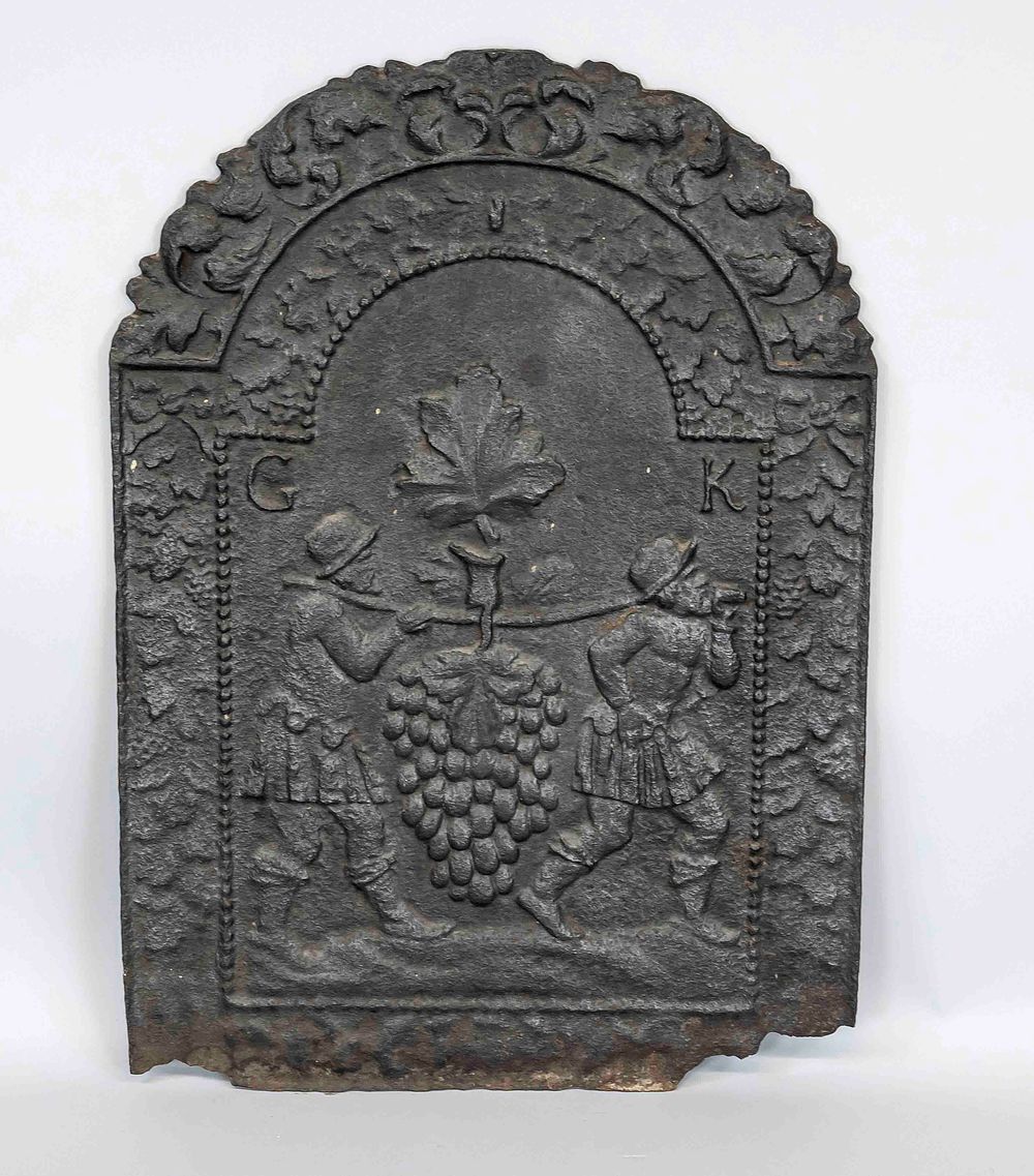 Fireplace plate, probably 18th century, iron. Rounded shape at the top, relief decoration with 