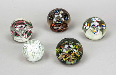 Five paperweights, 20th century, each spherical in shape, with enclosed glass flowers and air 