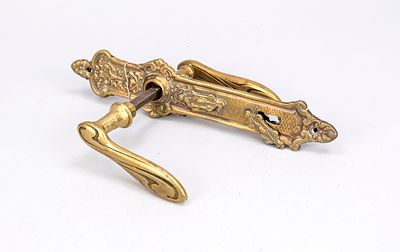 Art Nouveau door handle set, early 20th century, brass. Matching curved panel with floral 