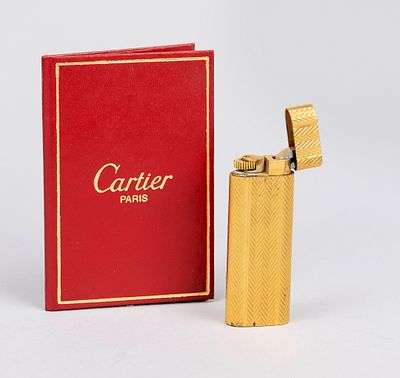 Briquet lighter by Cartier, 2nd half of the 20th century, guilloché and gold-plated metal. 