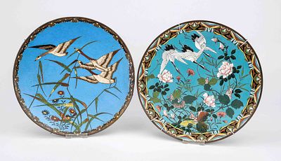 2 cloisonné plates, Japan, circa 1900 (Meiji). Both with flying cranes above blooming flowers 