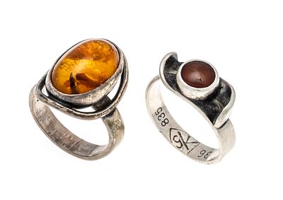 2 amber rings, 835/000 silver with 2 oval honey amber cabochons, 15–6 mm, partially rubbed 