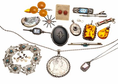 Large collection of silver jewelry, with pendants, brooches, necklaces, and a bracelet, with 