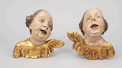 2 putto heads, 19th century or older, carved from lime wood, polychrome painted and partially 