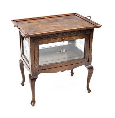 Tea cabinet, circa 1930, oak, fully glazed body with hinged door and removable tray, 72 x 74 x 49 cm