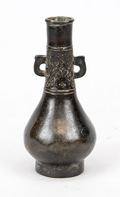 Small vase, China, Ming period or earlier, bronze. Elongated neck with handles and a relief 