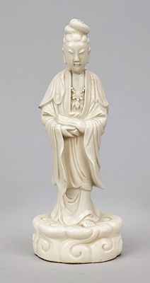 Blanc de chine Guanyin, China, 19th/20th century, standing on a pedestal of stylized clouds. 