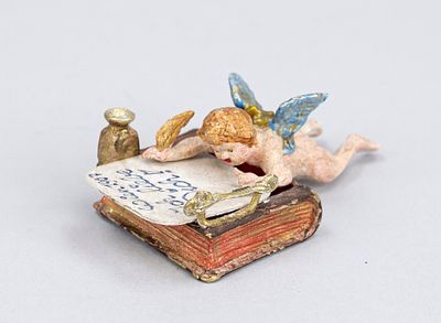 Viennese bronze, 20th century, polychrome cold-painted bronze in the form of a cherub writing a 