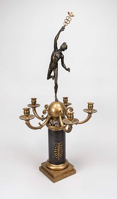 Figurative candlestick, 19th century, bronze, partially dark patina. Columnar shaft with a 