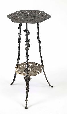 Art Nouveau side table, ca. 1900, cast iron, black lacquered. 2 openwork shelves on 3 legs with 