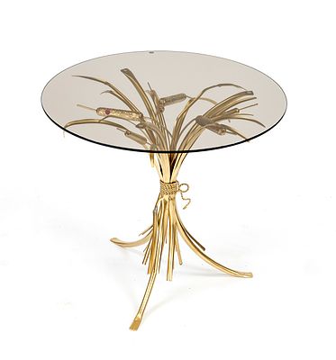 Small table, 20th century, round glass top on a gold-inlaid ear-shaped base, scuffed, H. 50 cm