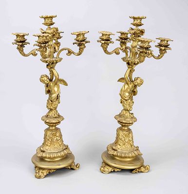 Pair of ornate figurative candelabra, 19th century, gilded brass (?). Rich relief decoration 