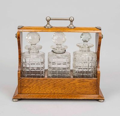 Open Tantalus home bar, England, 19th century. Oak carrying frame with metal fittings and 