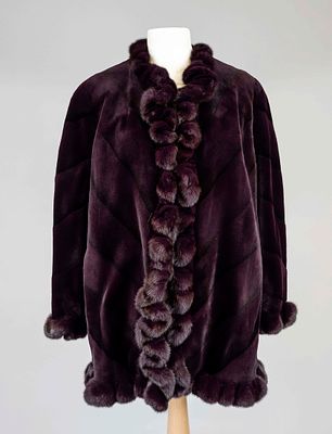 Short coat, plum-colored sheared mink with wavy trim, small stand-up collar, fastens with 