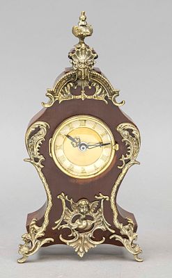 Mahogany table clock, 2nd half of the 20th century, decorated with brass ornaments, domed glass 