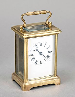 Small travel clock, circa 1880, with top-mounted handle, faceted glass on all sides, the 