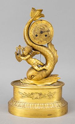 Gilded bronze pendulum clock, France, first half of the 19th century, a dolphin with a putto 