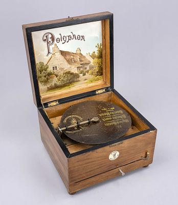 Polyphone with one perforated disc, Germany, late 19th century, wooden body on spherical feet 