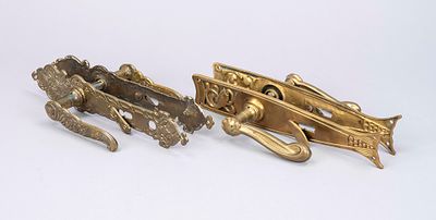 2 pairs of Art Nouveau door handle sets, circa 1900, brass. 1 pair with a gracefully curved 