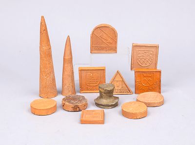 13 boundary markers, early 20th century, clay, some glazed. Various shapes. 10 with coats of 