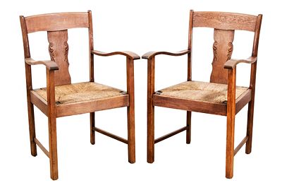 2 armchairs, circa 1910. Solid oak, rush-woven seat, 92 x 60 x 50 cm., The furniture is located 