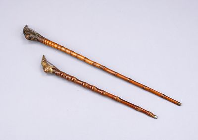 2 opium pipes, China, late 19th century (Qing). Mixed metals and bamboo, scuffed, L. up to 52 cm