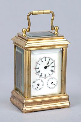 Gold-plated travel alarm clock, late 20th century, faceted glass on all sides, with top-mounted 