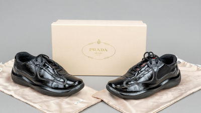 Prada, low-top sneaker, black patent leather and other materials, tongue with red logo patch 