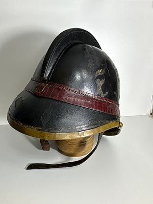 circa 1870: Early Helmet of the Gymnastics Fire Brigade – Leather with Red Band. Item 