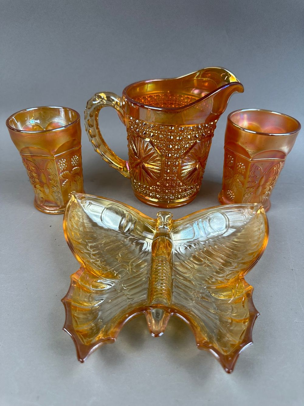 Lot 173: 4 Marigold Carnival Glass Butterfly Pitcher Tumbler
